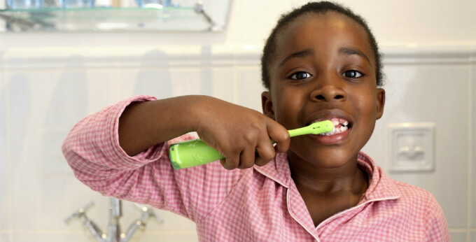 Kid brushing using electric toothbrush