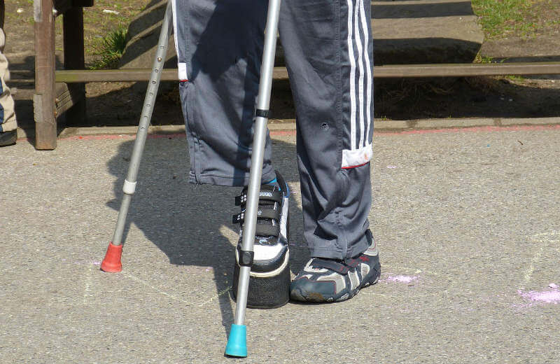 man walking on Crutches